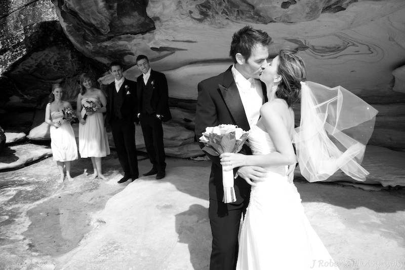 Bridal party under beach cliff - wedding photography